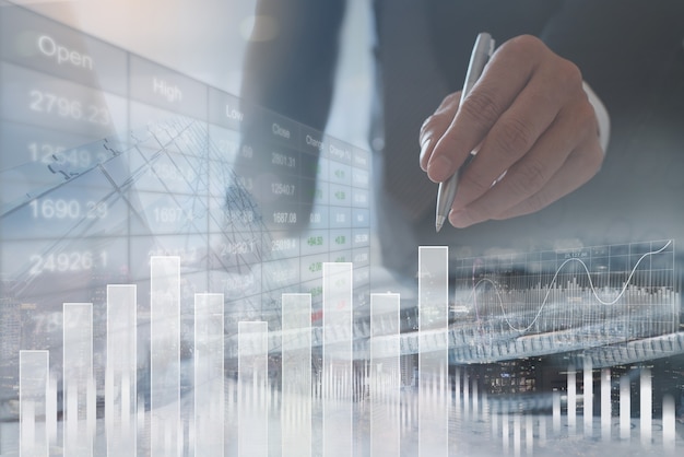 businessman analyzing sales data with financial graph on virtual screen