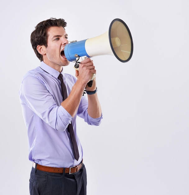 businessman angry and megaphone in studio for communication announcement and breaking news employee upset and loudspeaker on white background for broadcast noise and corporate propaganda protest