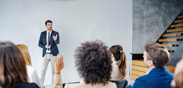 A businessman on answering questions on symposium