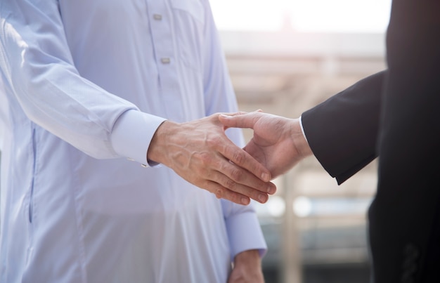 businessman arabic with engineer making handshake agreement