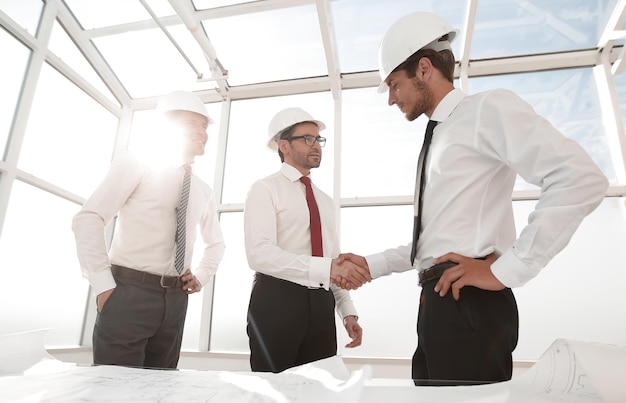 Businessman and architect shaking hands the concept of cooperation