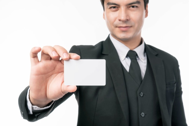 Businessman Asian handsome man wear a suit holding and showing empty business card , credit card or name card for advertising banner isolated on white background with copy space - business concept