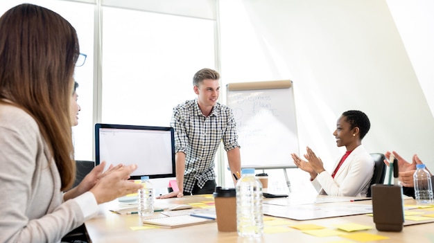 Businessman being congratulated by his colleagues