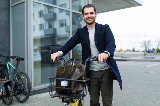 Businessman on a bicycle drives away from the office