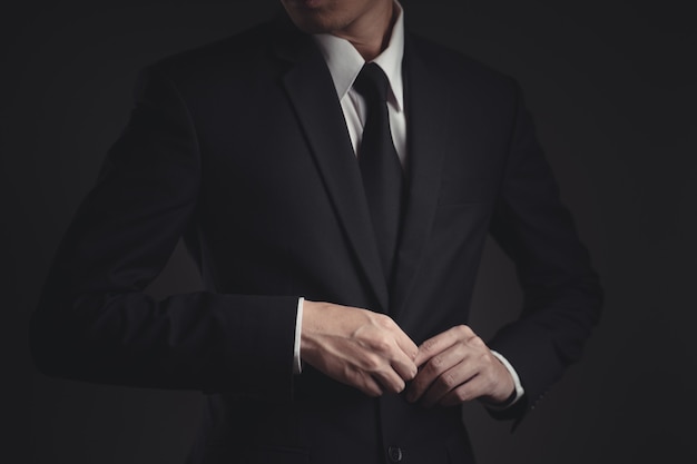 businessman in black suit on black