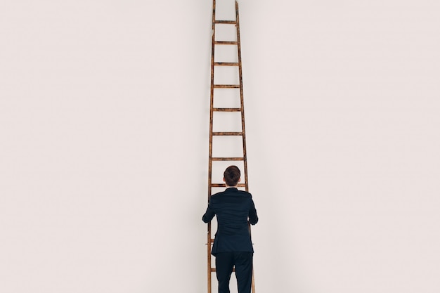 Businessman in black suit lift up the stair. Career and growth in business concept.