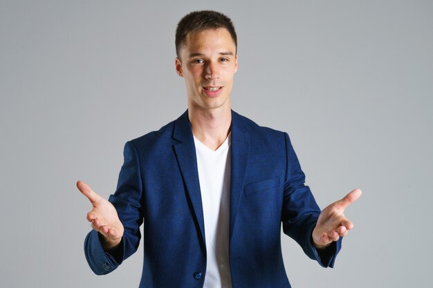 Businessman in blue jacket gestures with his hands