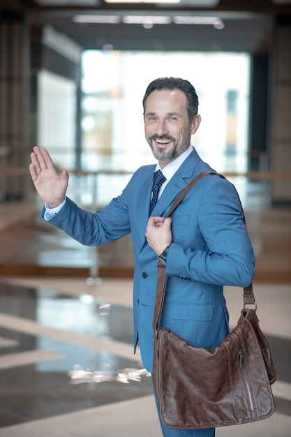 Businessman in a blue suit with a bag