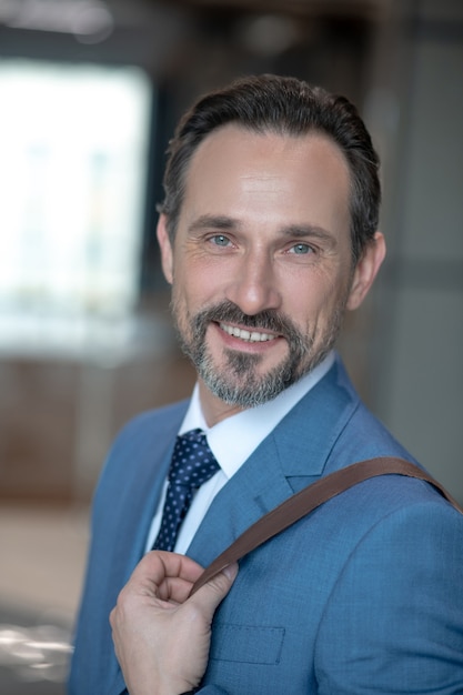 Businessman in a blue suit with a bag