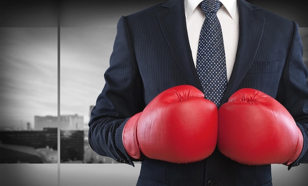 businessman in boxing gloves on background