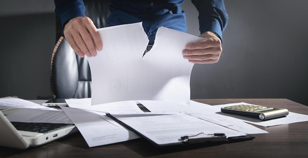 Photo businessman breaking contract at office.