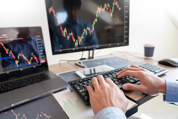 Businessman broker Analysing finance data graphs and reports on screen