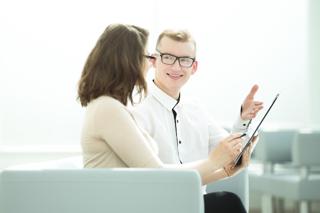 Businessman and business woman discussing the terms of the contract