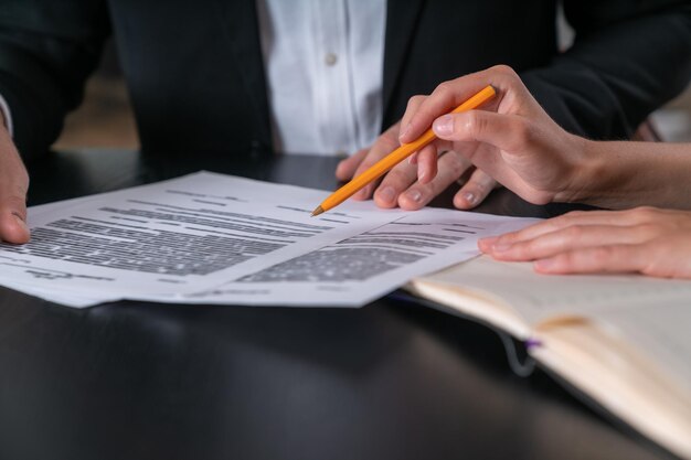 Businessman and businesswoman in formal suit discuss signing contract