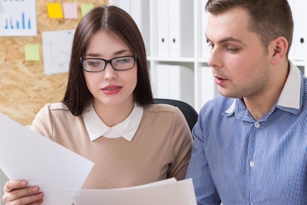 Businessman and businesswoman in office