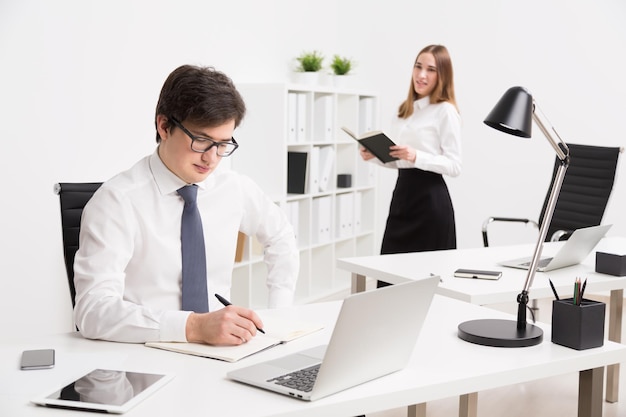 Businessman and businesswoman in office