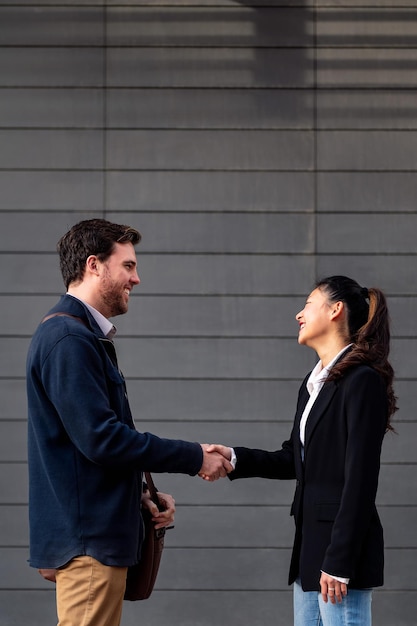 Businessman and businesswoman shaking hands