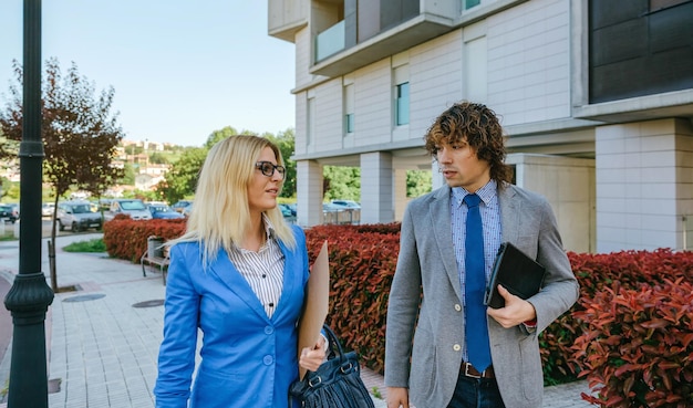 Businessman and businesswoman walking down the street