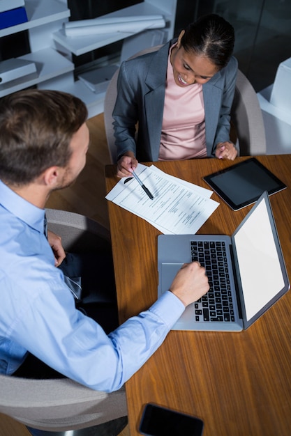 Businessman and businesswoman working in office