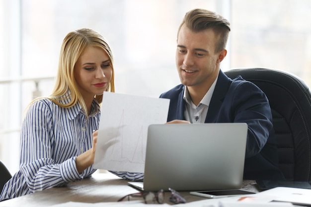 Businessman and businesswoman working in office