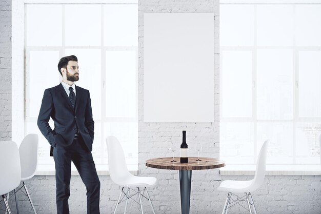 Businessman in cafe with poster