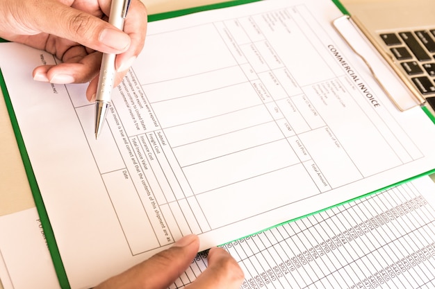 businessman calculate bills in workplace with paper.