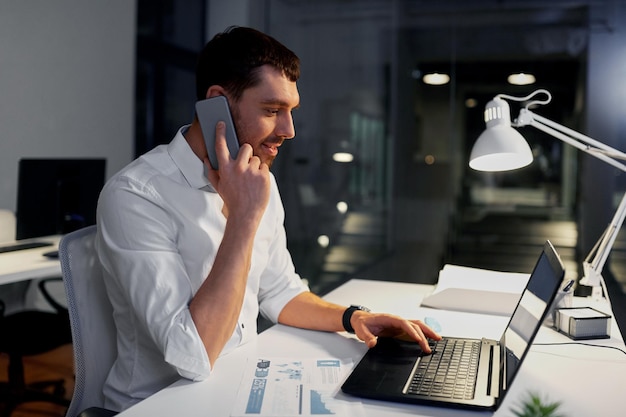 businessman calling on smartphone at night office