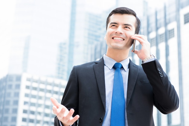 Businessman calling on smartphone 