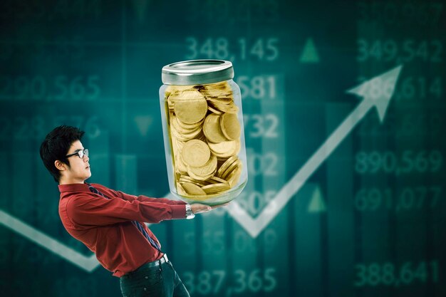 Businessman carrying money in a glass jar with coins inside