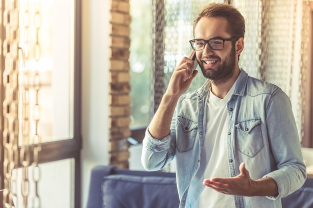 Businessman in casual wear is talking on the mobile phone