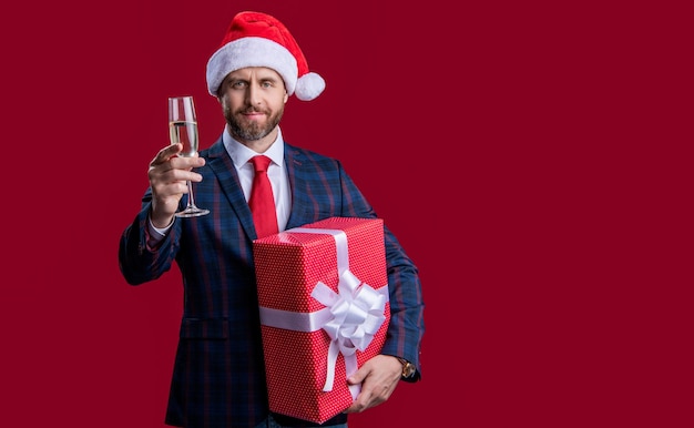 Businessman celebrate xmas isolated on red copy space xmas businessman with present celebrate