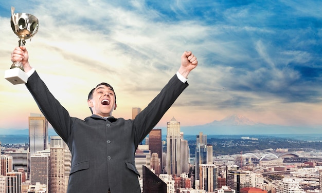 Businessman celebrating with trophy in hand