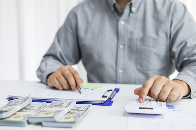 Businessman checking bills. taxes bank account balance and calculating annual financial statements of company. Accounting Audit Concept.