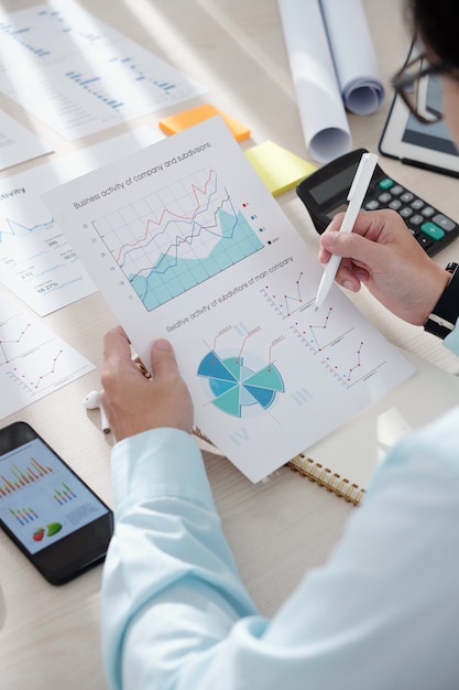 Businessman checking chart showing activity of company and subdivisions