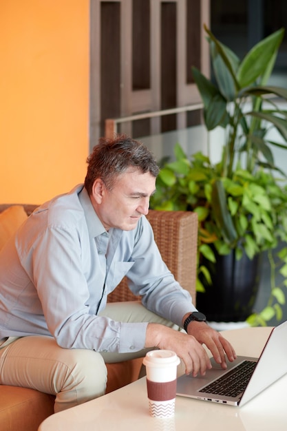 Businessman Checking E-mails on Laptop