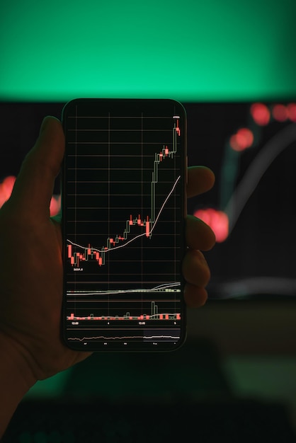 Businessman checking stock market data using a smartphone phone Concept of the analysis economy data and trading on crypto chain market platform