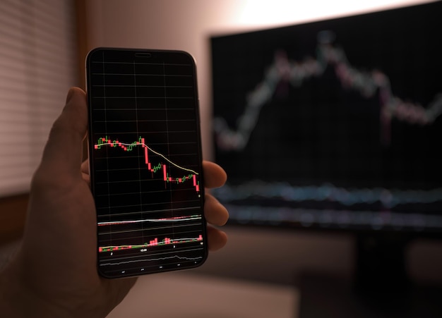 Businessman checking stock market data using a smartphone phone\
concept of the analysis economy data and trading on crypto chain\
market platform