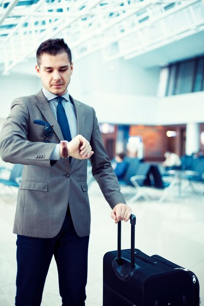 businessman checking time at airport