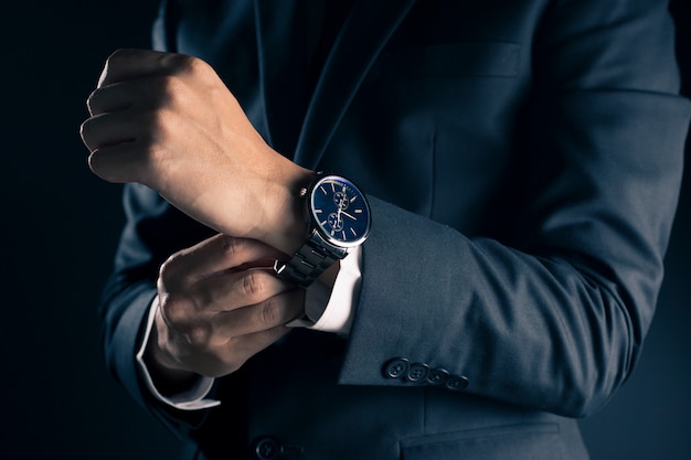 Businessman checking time from watch