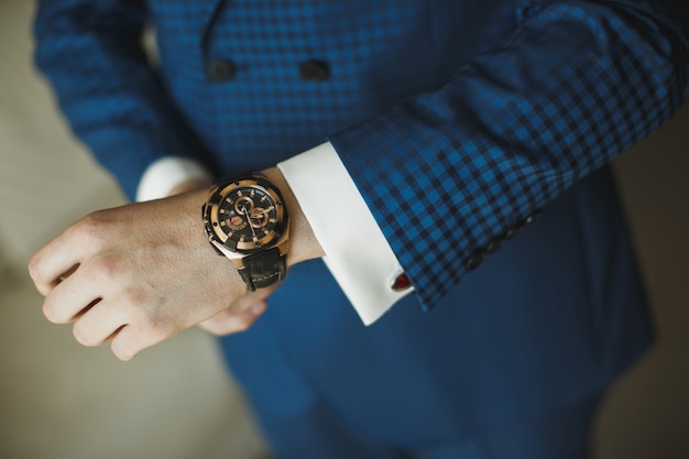 Businessman checking time from watch