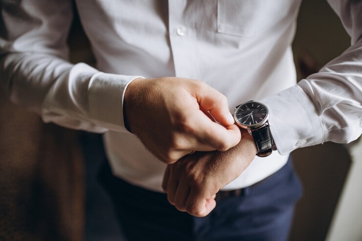 Photo businessman checking time on his wrist watch, man putting clock on hand,groom getting ready in the morning before wedding ceremony