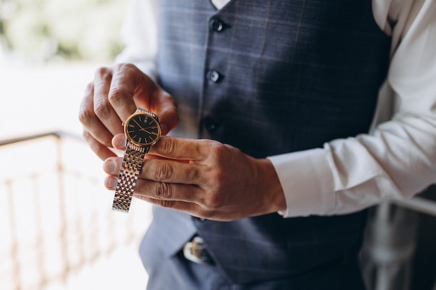 Businessman checking time on his wrist watch