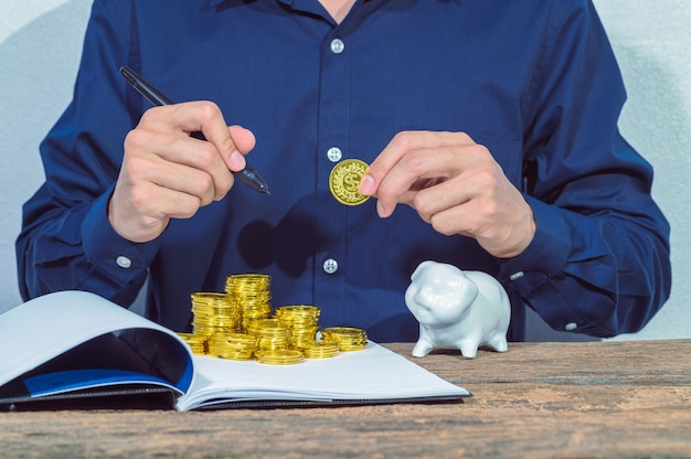 Businessman checks accounts documents and money saving ideas on the table