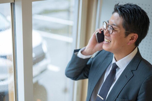 A businessman cheerfully answering the phone