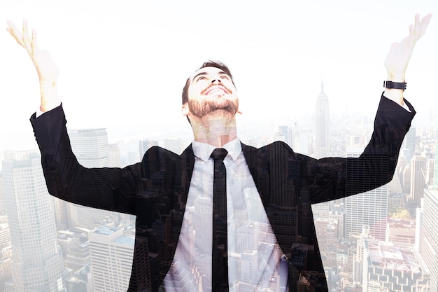 Businessman cheering with hands raised against new york skyline