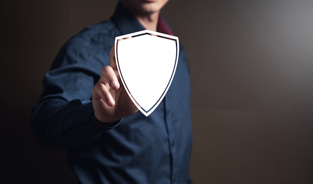 Businessman clicks on virtual shield