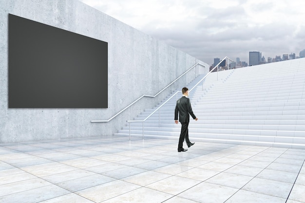 Businessman climbing concrete stairs