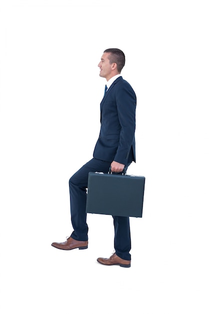 Businessman climbing with briefcase