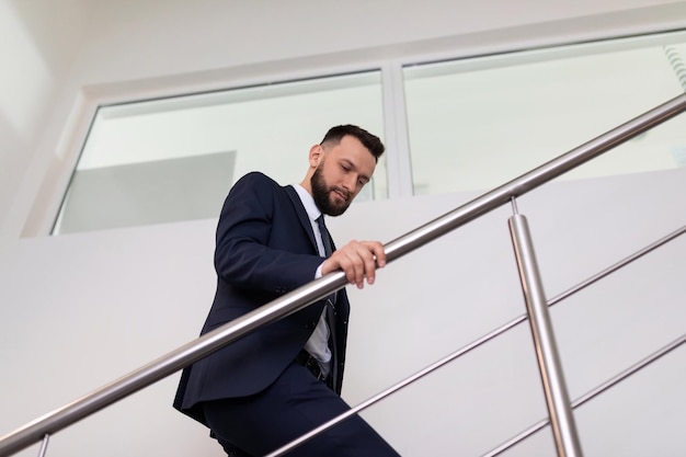 Businessman climbs the stairs up concept of success