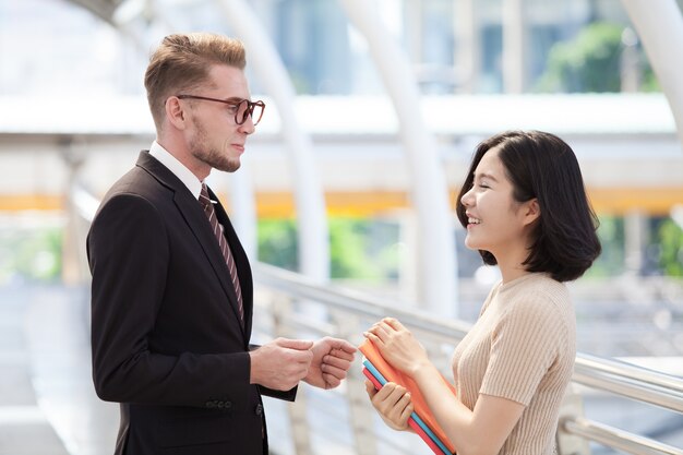 Businessman and college students discussing education 